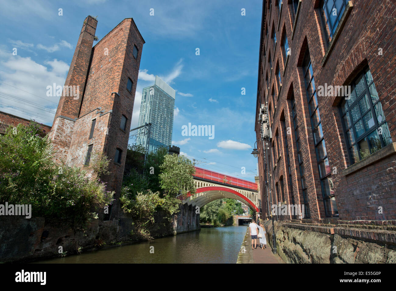 The Castlefield historic inner city canal area including a bridge and Beetham Tower (background) in Manchester UK/ Stock Photo