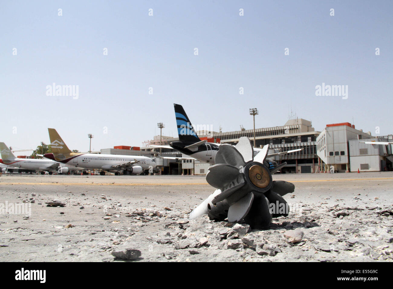 Tripoli, Libya. 21st July, 2014. The picture taken on July 21, 2014 shows a rocket propelled grenade hit into the tarmac of Tripoli International Airport, Libya. The airport has been under constant attack by Islamist fighters since July 13 with the death toll reaching 47. Credit:  Hamza Turkia/Xinhua/Alamy Live News Stock Photo