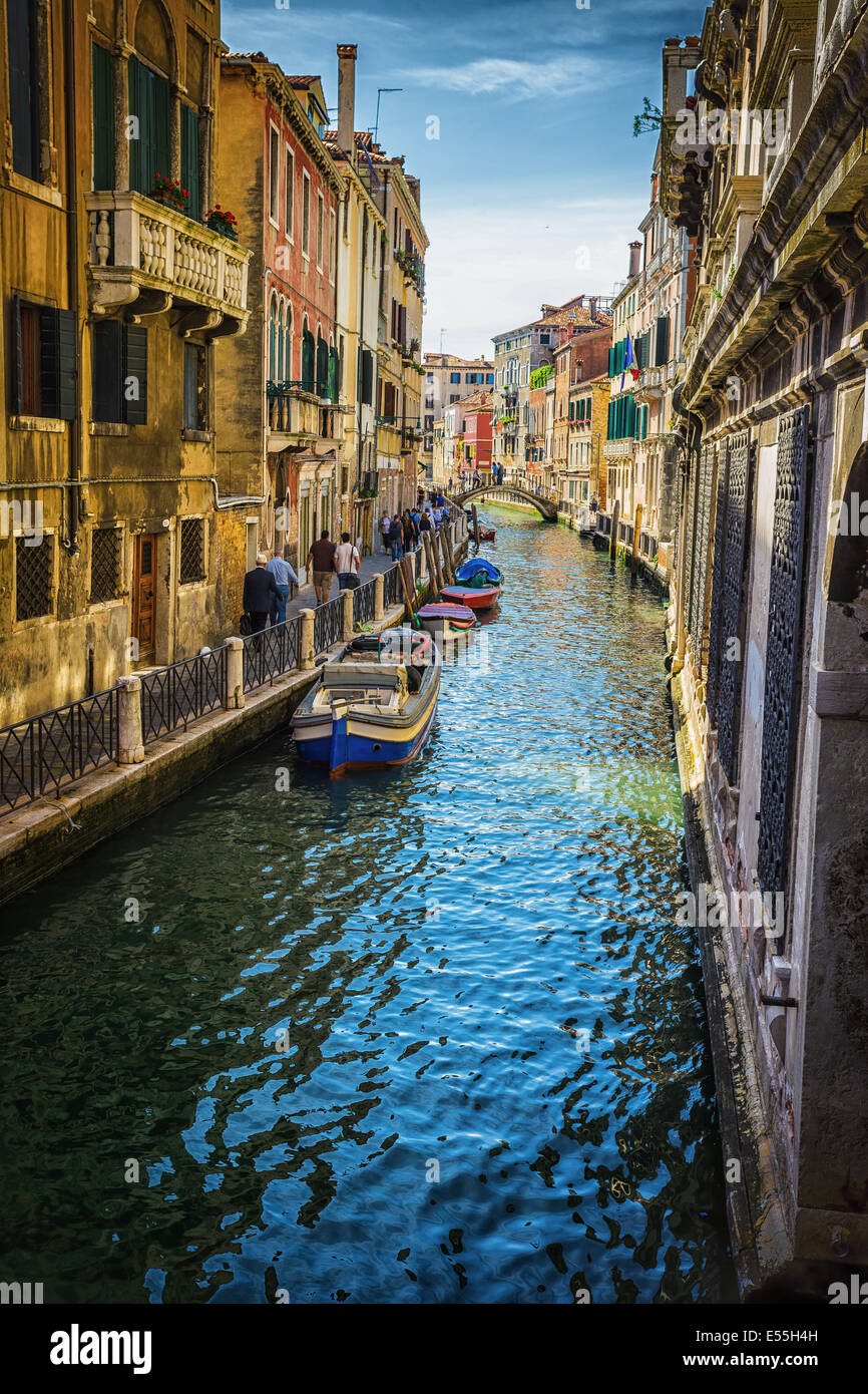 Narrow canal among old colorful brick houses in Venice, Italy Stock ...