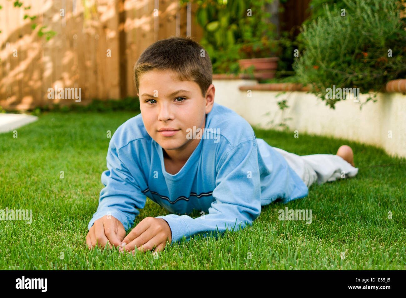 9-10 year old young person people Japanese/Caucasian boy backyard serious eye contact looking camera thoughtful dreaming thinking s MR  © Myrleen Pearson Stock Photo