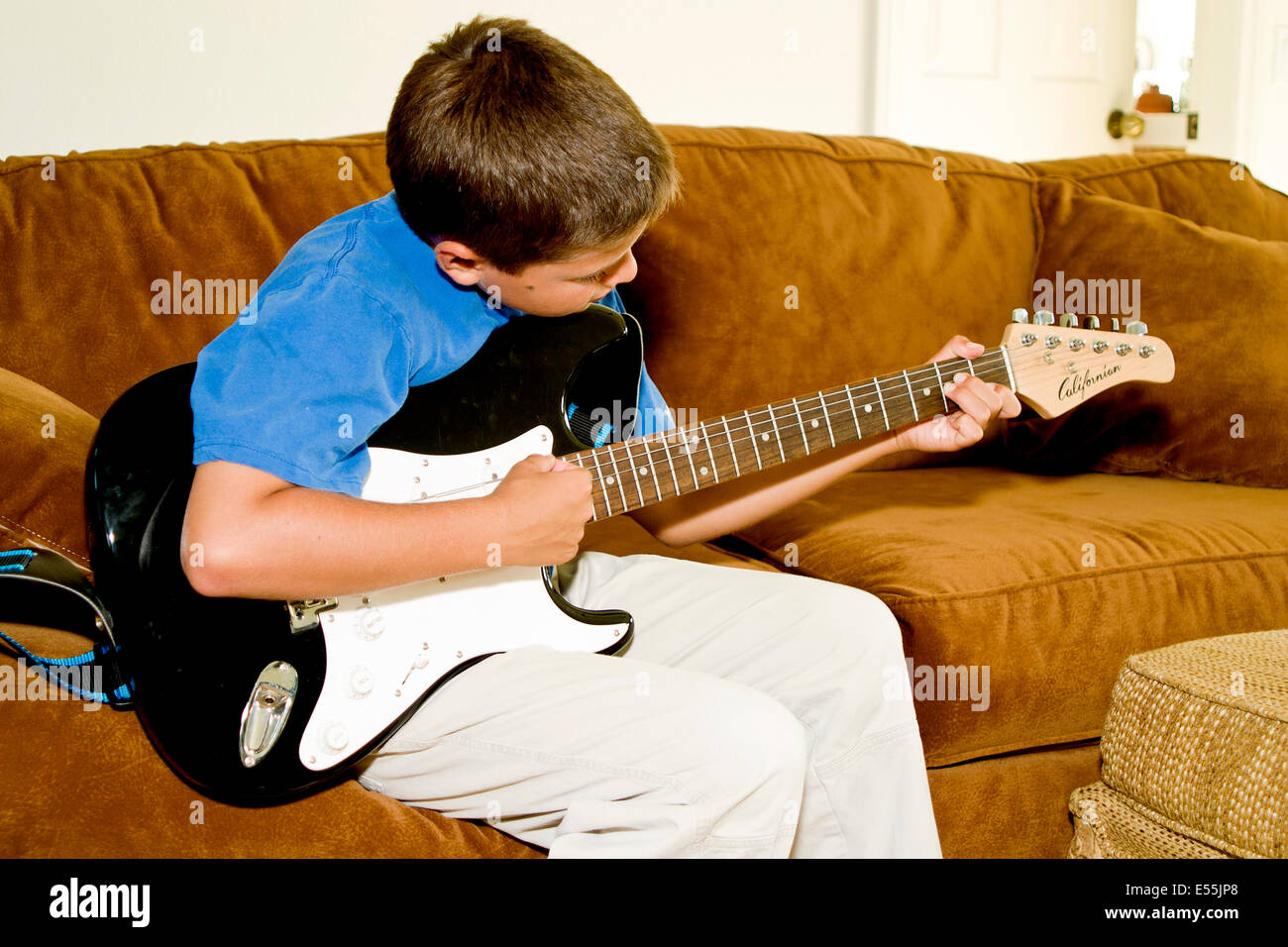 young Japanese Caucasian boy playing guitar. MR © Myrleen Pearson Stock Photo