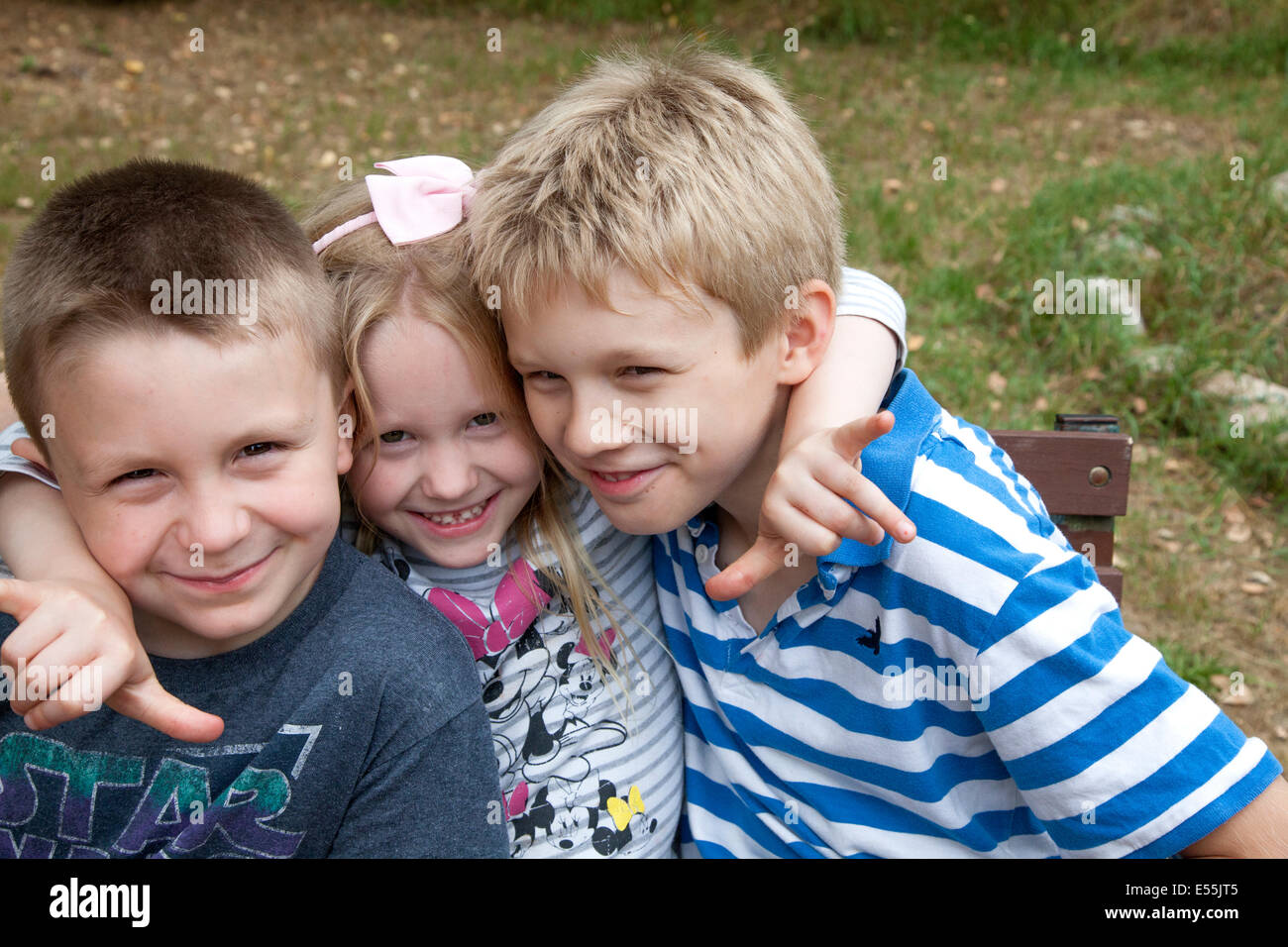 Three happy Polish sibling children hugging to help their grandfather Steve's stock photo business. Zawady Poland Stock Photo