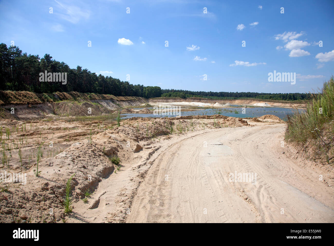 Degradation of Polish field into a sand pit pond made by mining sand for construction. Zawady Poland Stock Photo