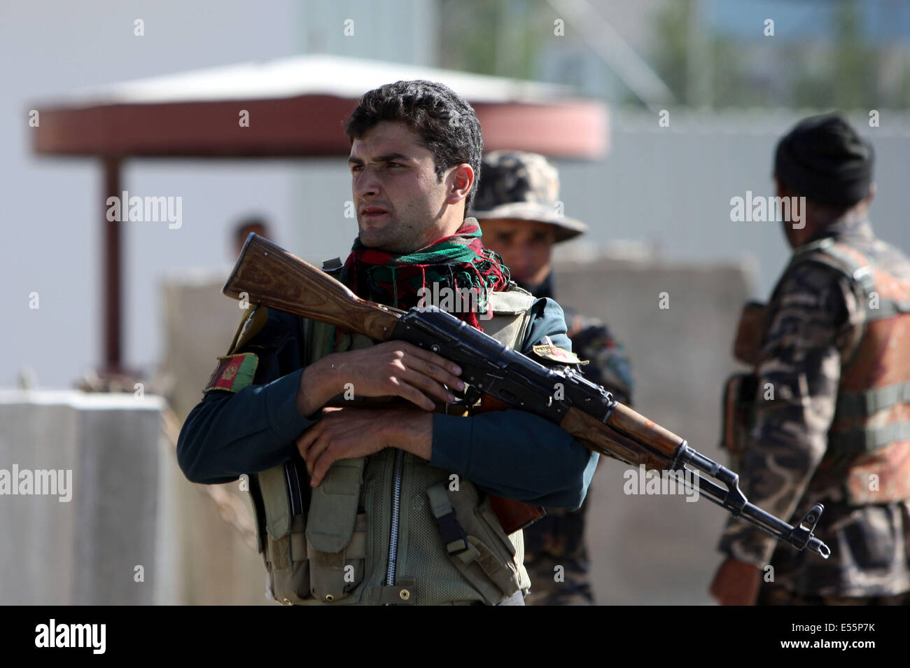 Kabul, Afghanistan. 22nd July, 2014. An Afghan soldier stands guard at the site of suicide attack outside the entrance gate of Interior Ministry compound in Kabul, Afghanistan, July 22, 2014. At least four people, including three foreigners, were killed and six others wounded in a suicide bombing near the Kabul airport on Tuesday morning, sources said. Credit:  Ahmad Massoud/Xinhua/Alamy Live News Stock Photo