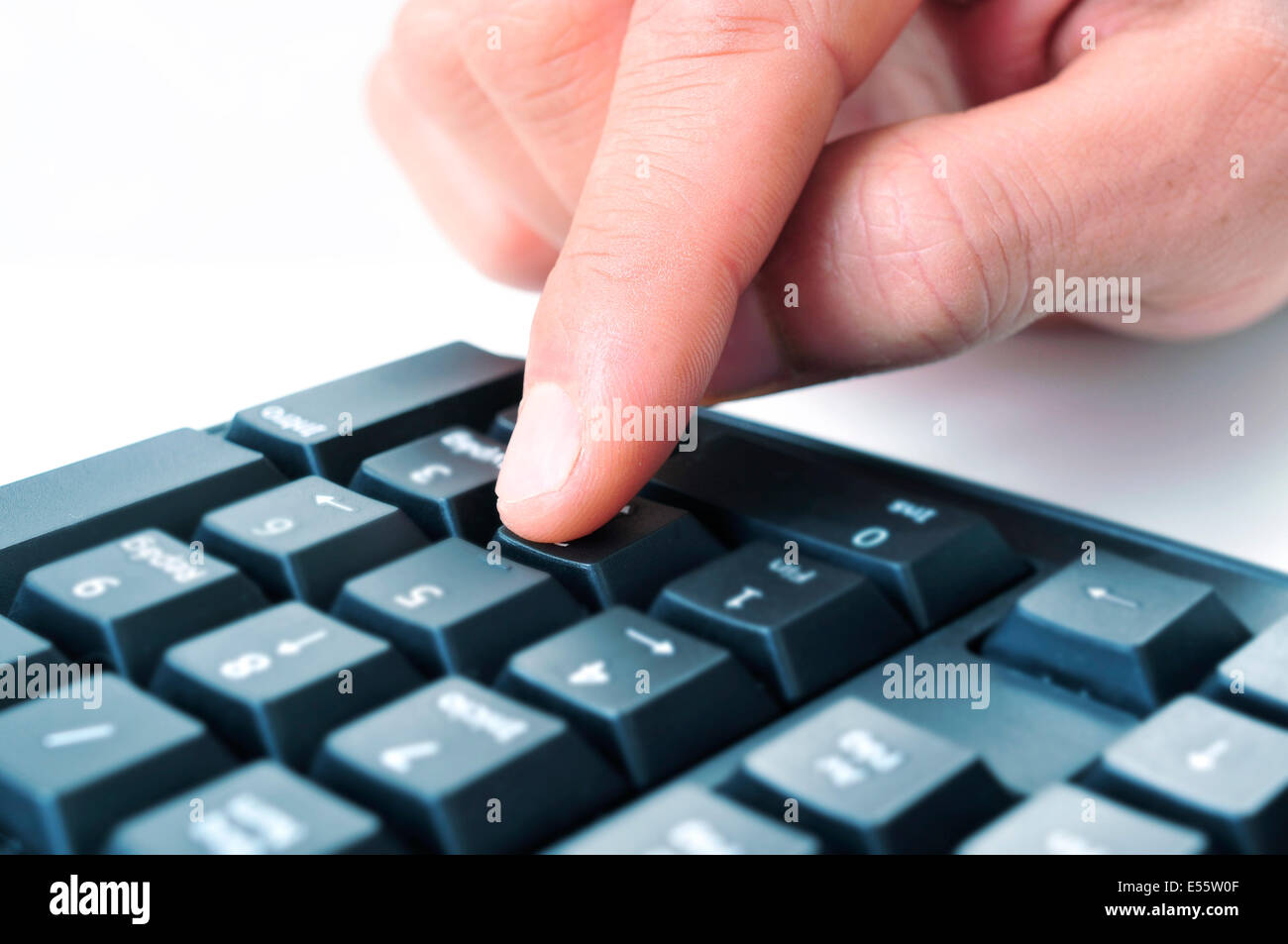 closeup of the hand of a man using the numeric keypad of a computer keyboard Stock Photo