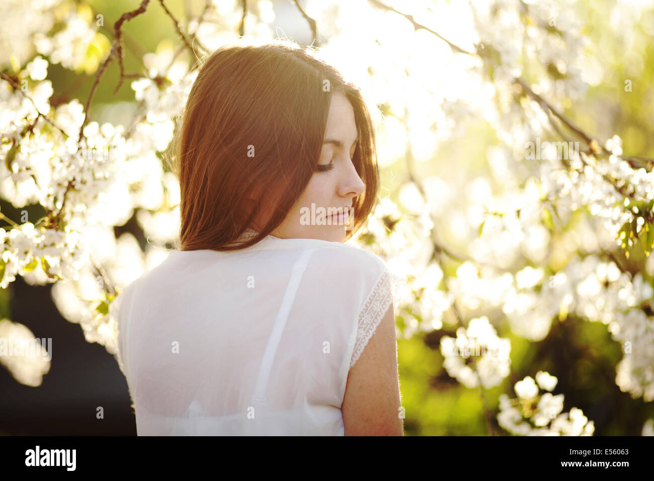 Portrait of a young woman with cherry blossoms Stock Photo