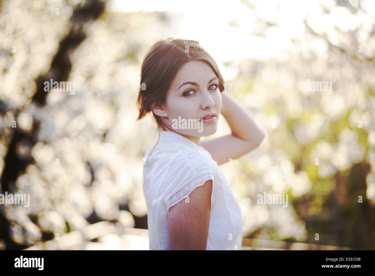 Portrait of a young woman with cherry blossoms Stock Photo