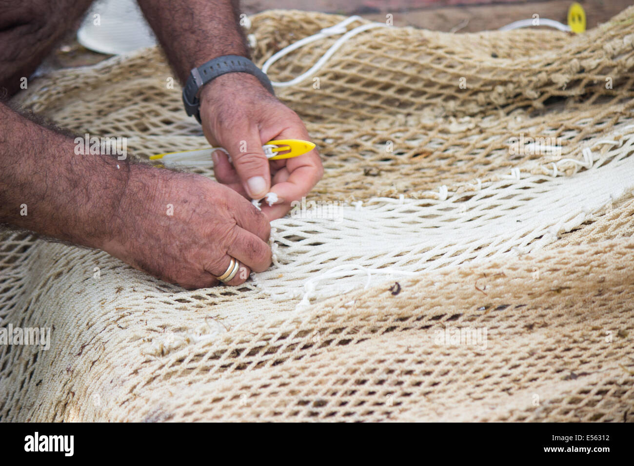 man weaving fishing net hands skill making fishnet Stock Photo