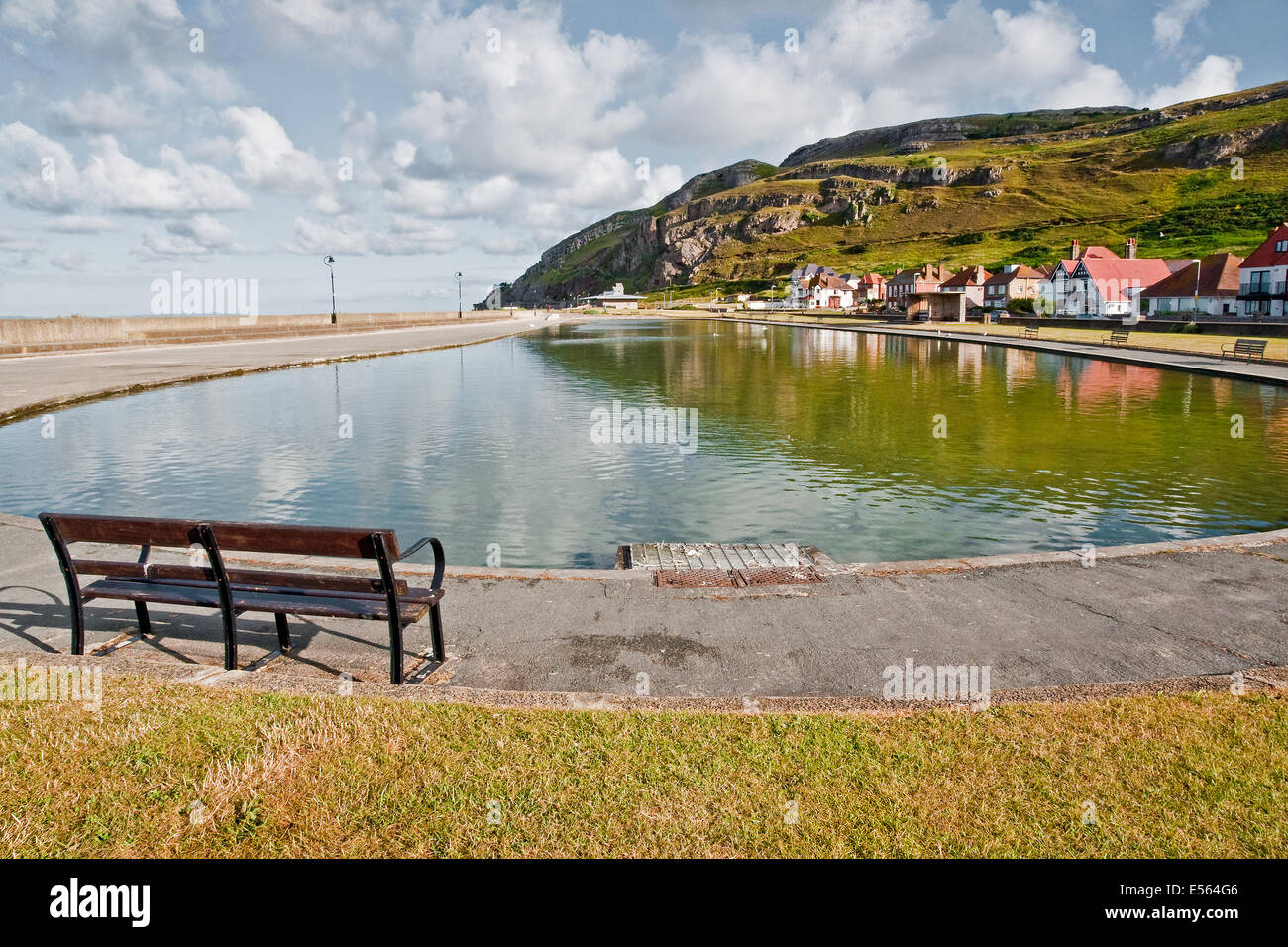 Early morning sunlight on the Model Boating Lake, West Shore, Llandudno, with the Great Orme in the background Stock Photo