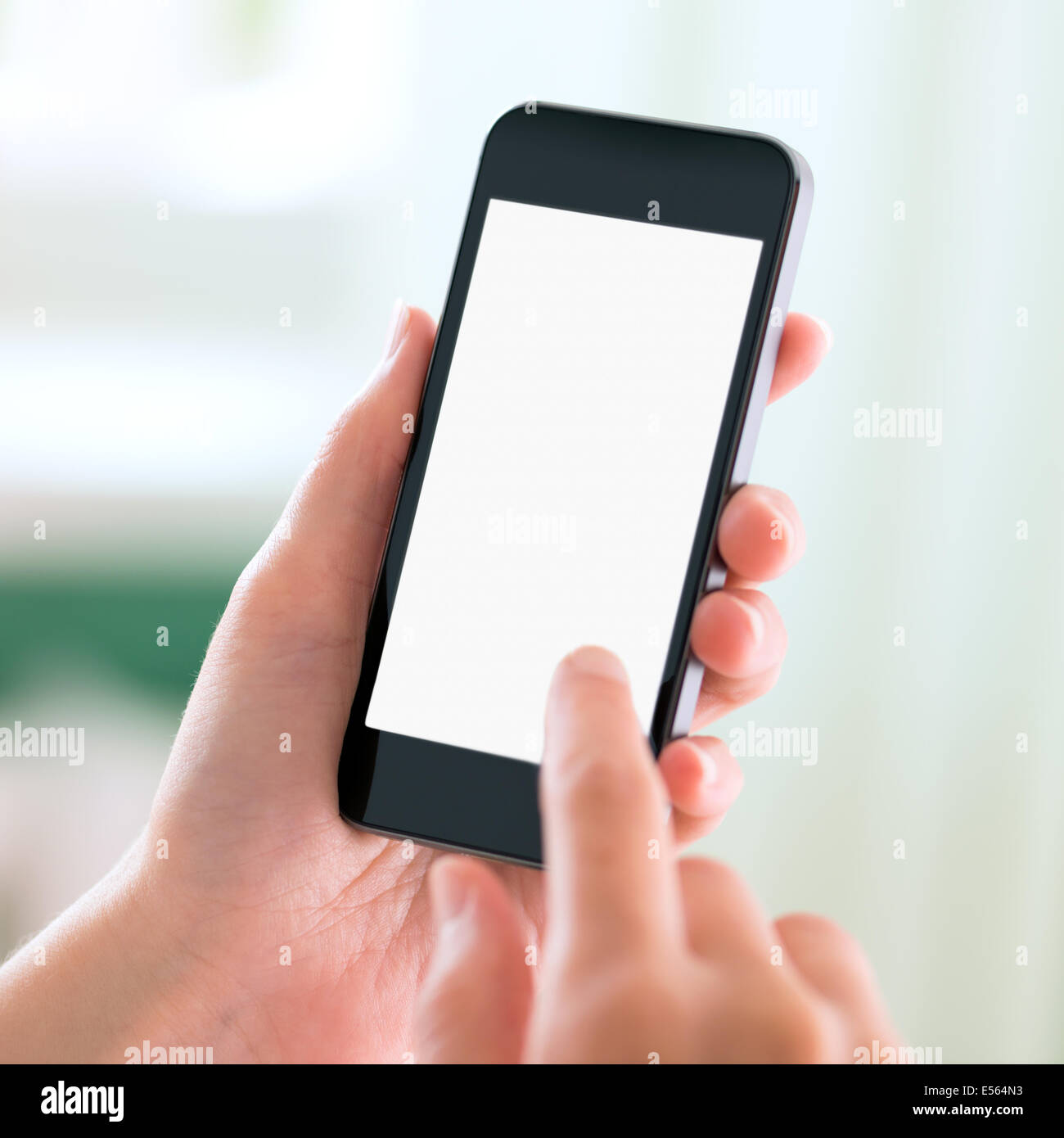 Female hands holding and touching on modern mobile smart phone with blank screen. Isolated on white background. Stock Photo