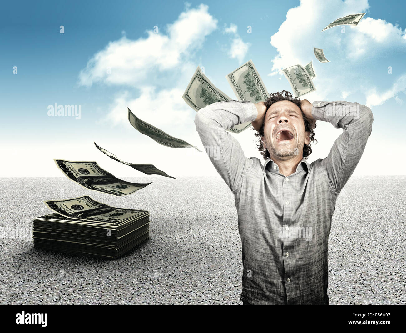 desperate man and flying dollars money Stock Photo