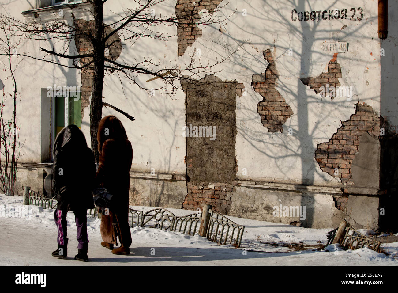 Street wall exposed brick Russian couple walk Stock Photo