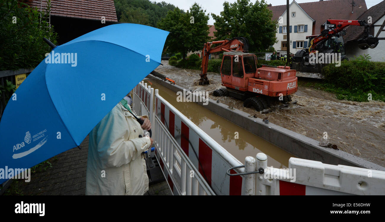 Ehrenkirchen, Germany. 22nd July, 2014. An excavator stands in the river Moehlin, which carries high water, in Ehrenkirchen, Germany, 22 July 2014. Heavy rains have swelled the levels of rivers in the south of Baden-Wuerttemberg. Photo: PATRICK SEEGER/DPA/Alamy Live News Stock Photo
