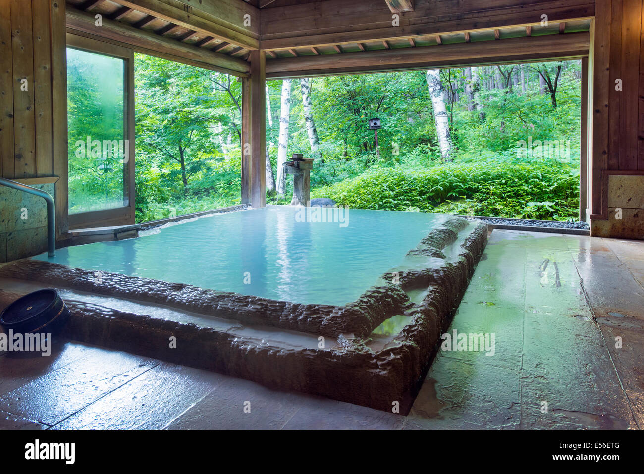 Typical Japanese rotenburo hotspring onsen. This is in Shirahone Onsen Nagano and looks out over the natural forest Stock Photo