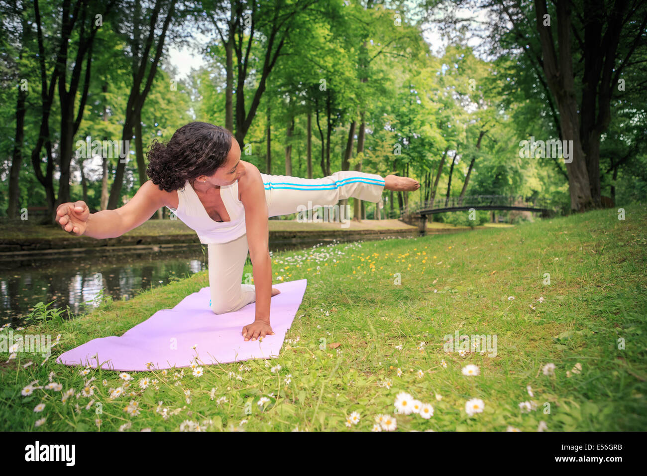 woman making yoga exercise in an old park Stock Photo