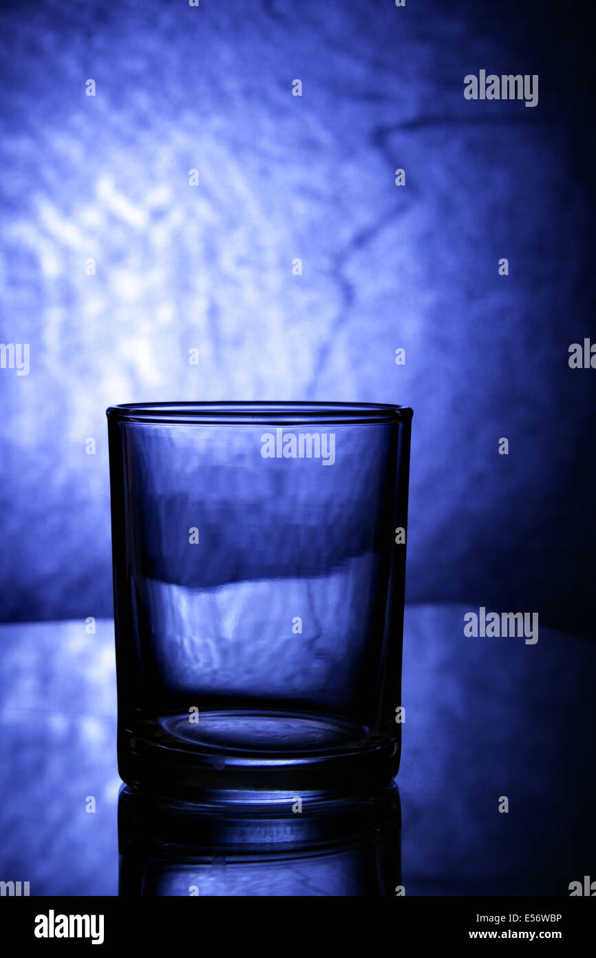 Empty glass close up over blue textured background Stock Photo