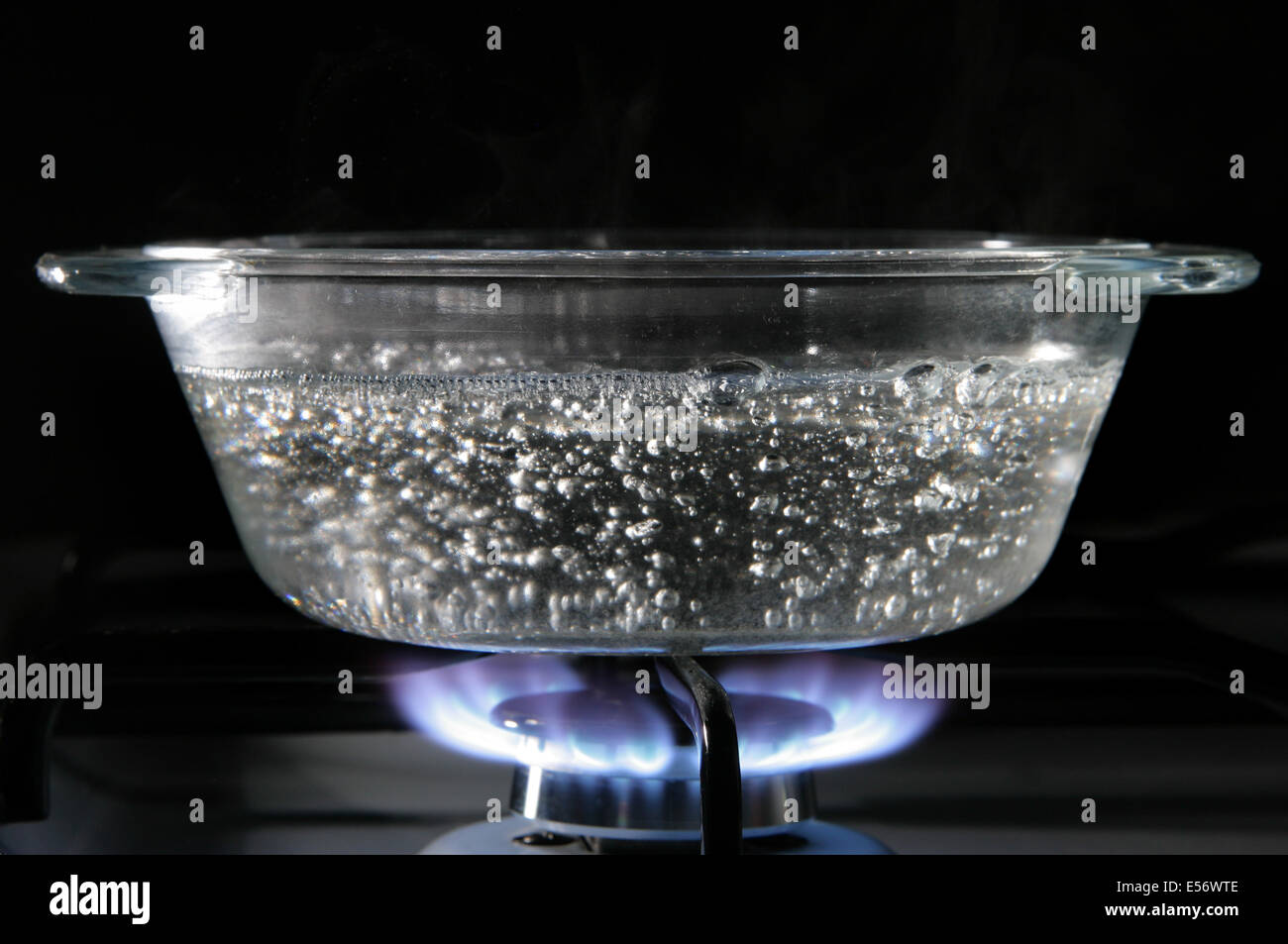 Glass saucepan on the gas stove close-up Stock Photo