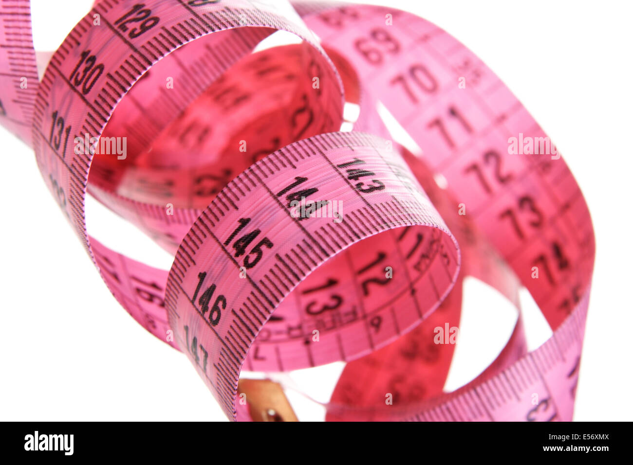 Pink measuring tape isolated over white background Stock Photo - Alamy
