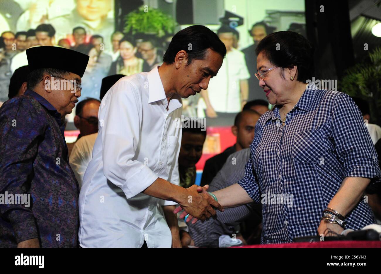 Jakarta, Indonesia. 22nd July, 2014. Indonesia's presidential candidate from the Indonesian Democratic Party of Struggle (PDIP) Joko Widodo (C) shakes hands with the party's Chairperson Megawati Soekarnoputri (R), accompanied by his running mate Jusuf Kalla (L) after a press conference ahead of announcement of recapitulation 2014 presidential election in Jakarta, Indonesia, July 22, 2014. The General Election Commission (KPU) is scheduled to release the vote tally results this afternoon, qualifying the winner of election. Credit:  Zulkarnain/Xinhua/Alamy Live News Stock Photo