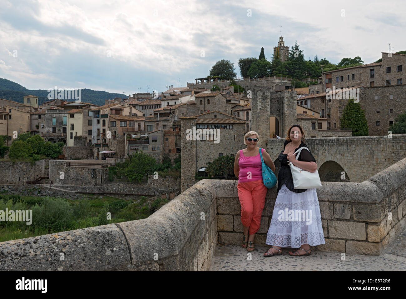 Portrait of mother and daughter on background of medieval town of Besalu, Catalonia, Spain. Stock Photo