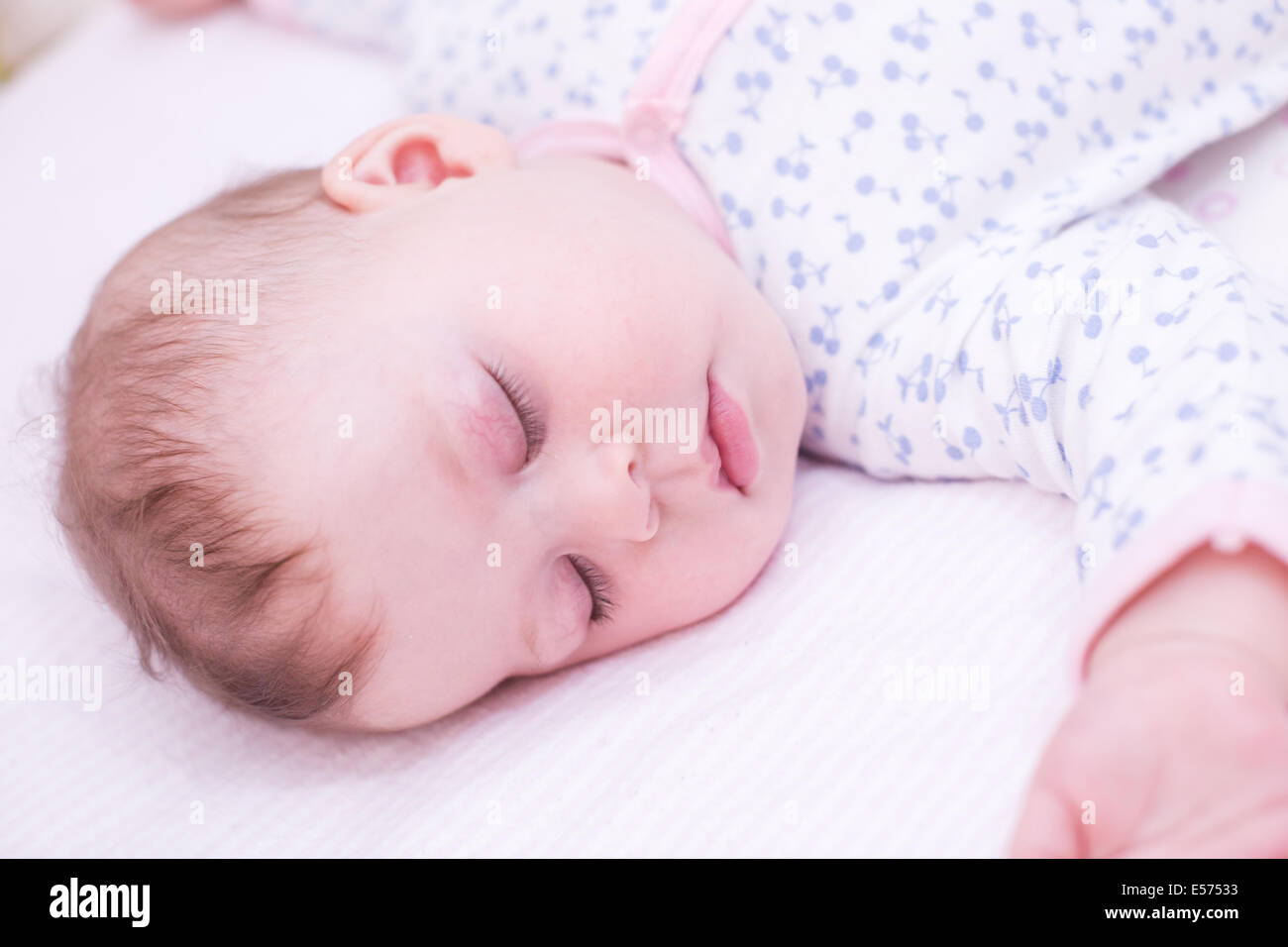 Cute baby girl sleeping in her crib Stock Photo - Alamy
