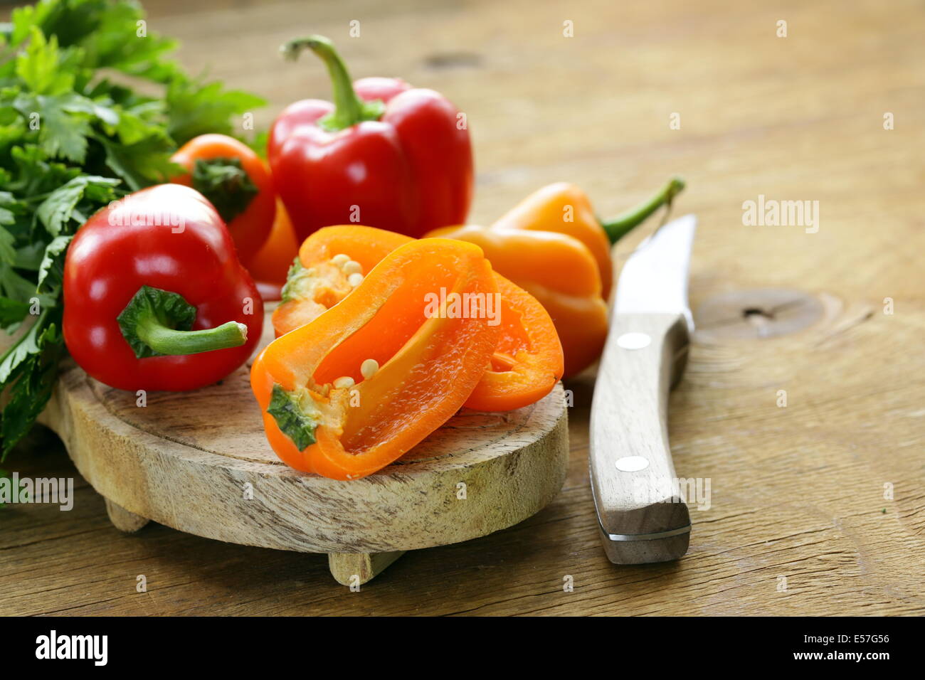fresh colorful bell peppers on a wooden background Stock Photo - Alamy