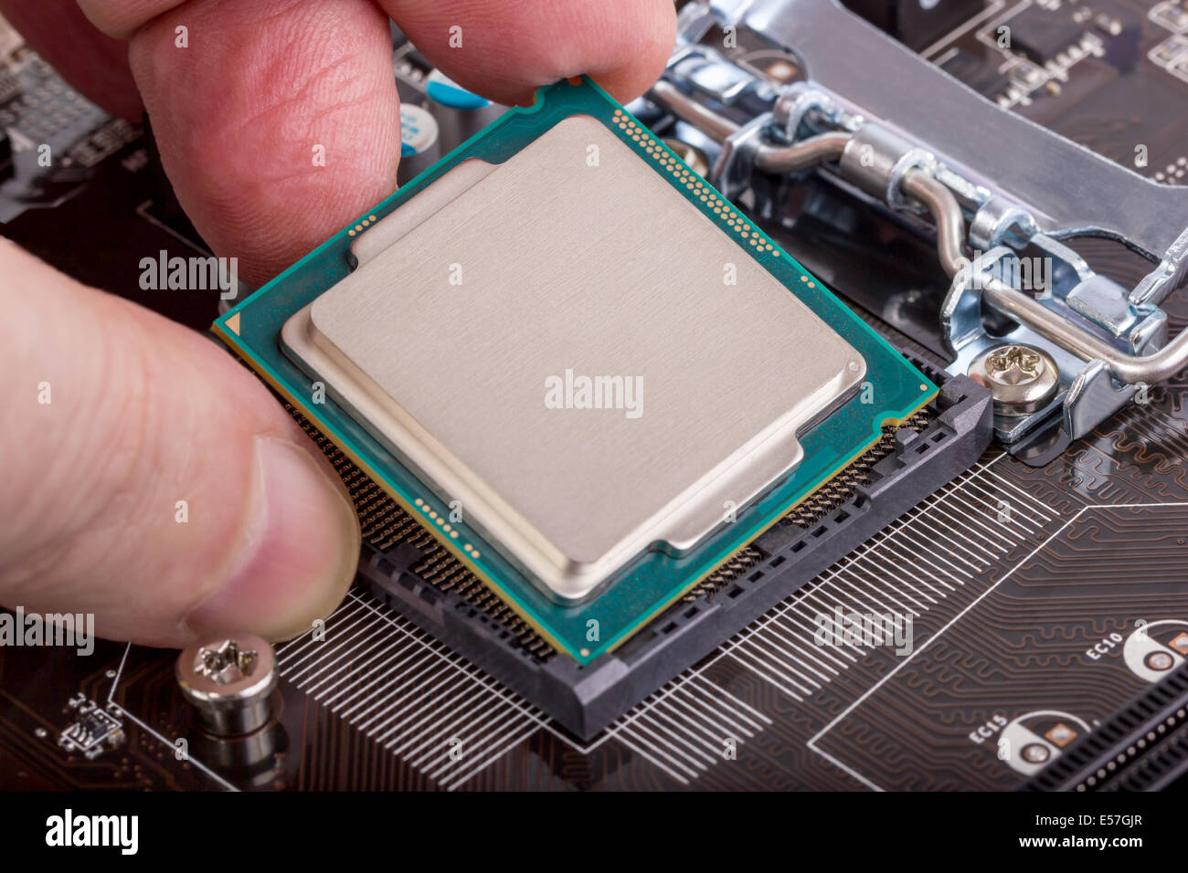 Installation of modern processor in CPU socket on the motherboard Stock Photo