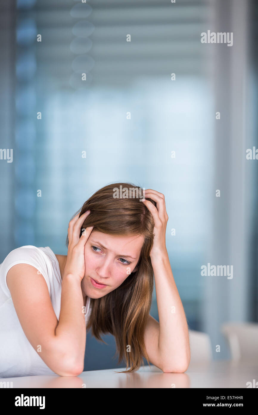 Portrait of an unhappy woman in chains. Crisis and depression. Stock Photo