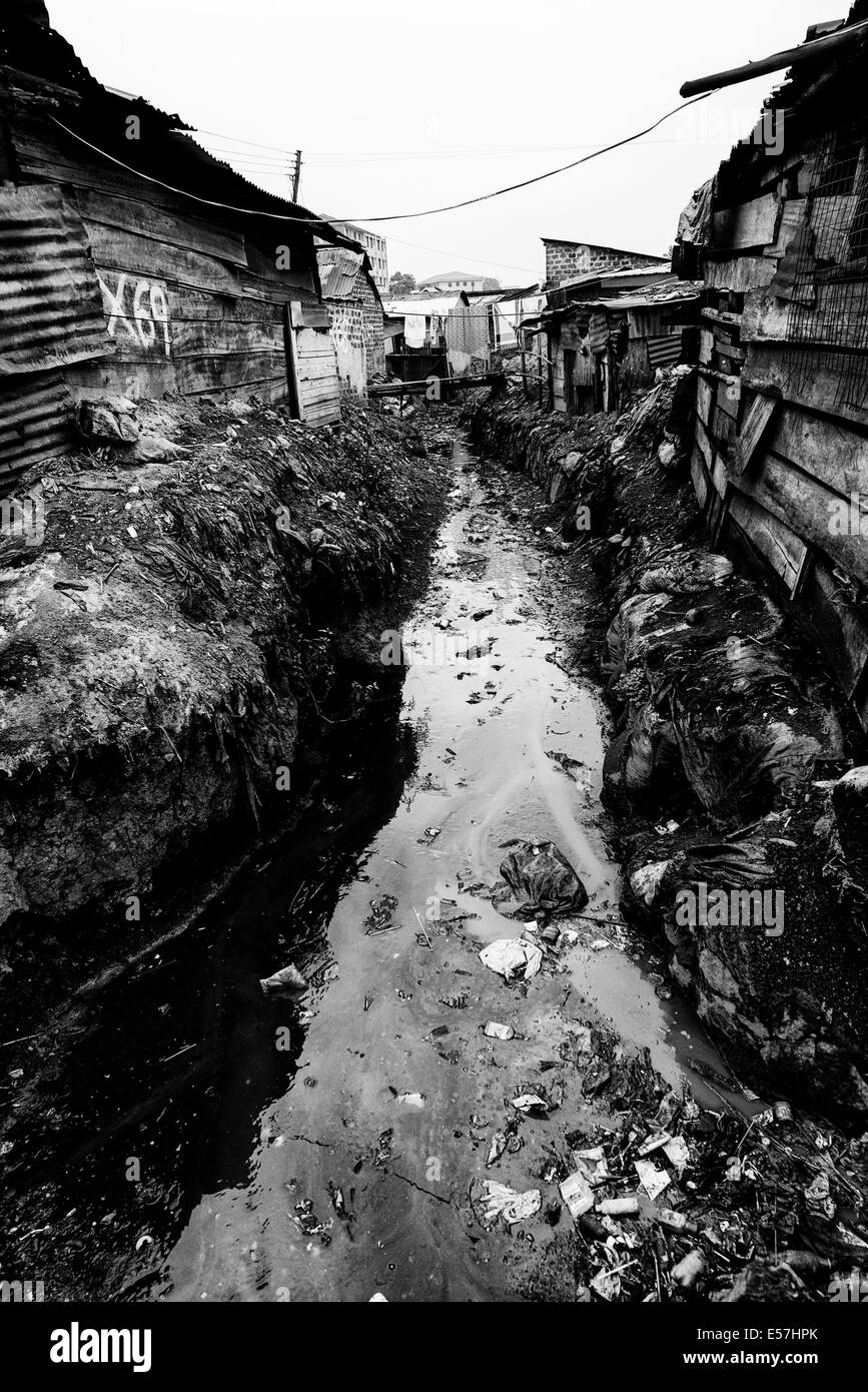 Jul 28, 2013 - Kampala, Uganda - A main stream, fairly stagnant runs through the middle of this community and is taken as a water source for washing, cooking and often as toilet. No permanent fresh water is available. Katanga in Kampala is a slum community where more than 20,000 people live under conditions of extreme poverty and without basic infrastructure such as permanent fresh water supply and brick houses, Amidst the shanty homes a group of ambitious fighters are trying to reach for a better life. Whilst gathering banana peels in order to survive, they are passionate about boxing, and th Stock Photo