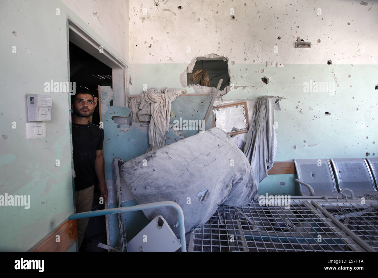 Deir Al Balah, Gaza Strip. 21st July, 2014. A Palestinian looks at a hospital room damaged by Israeli shelling. Credit:  Eloise Bollack/ZUMA Wire/Alamy Live News Stock Photo