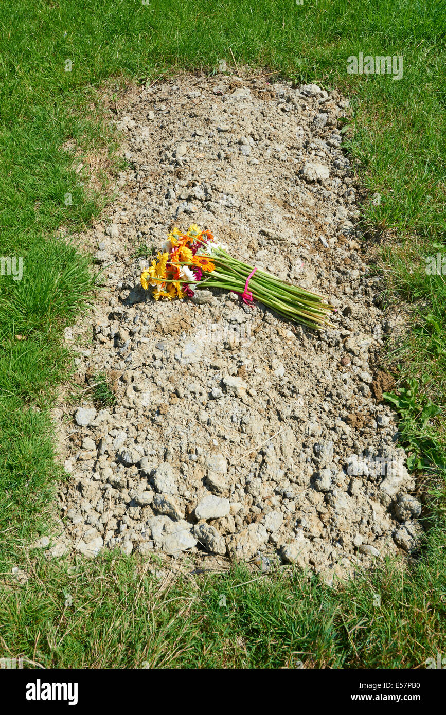 Simple Grave With Flowers At Sun Rising Natural Burial Ground and