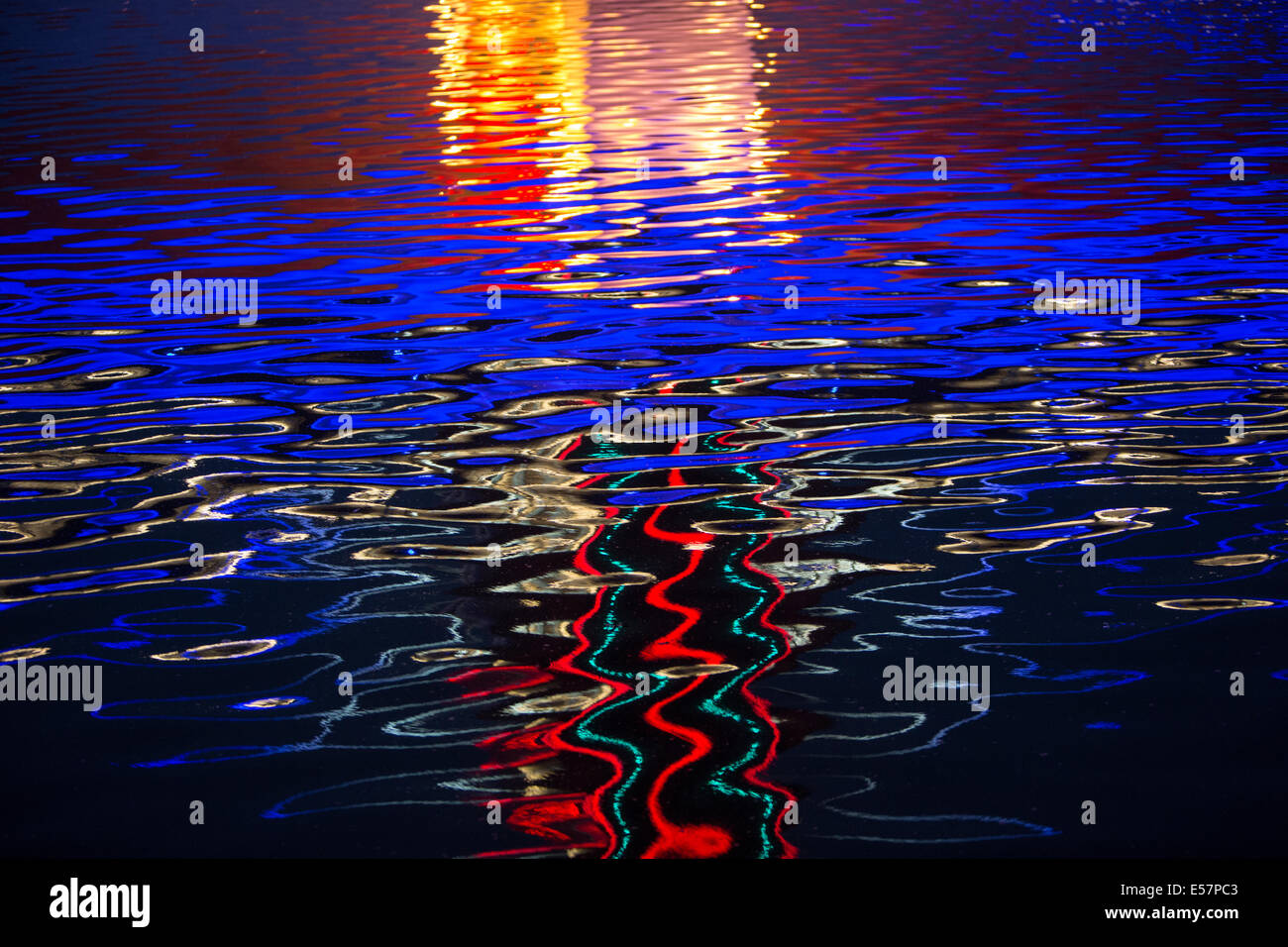 Colourful lights reflected on rippling water Stock Photo - Alamy