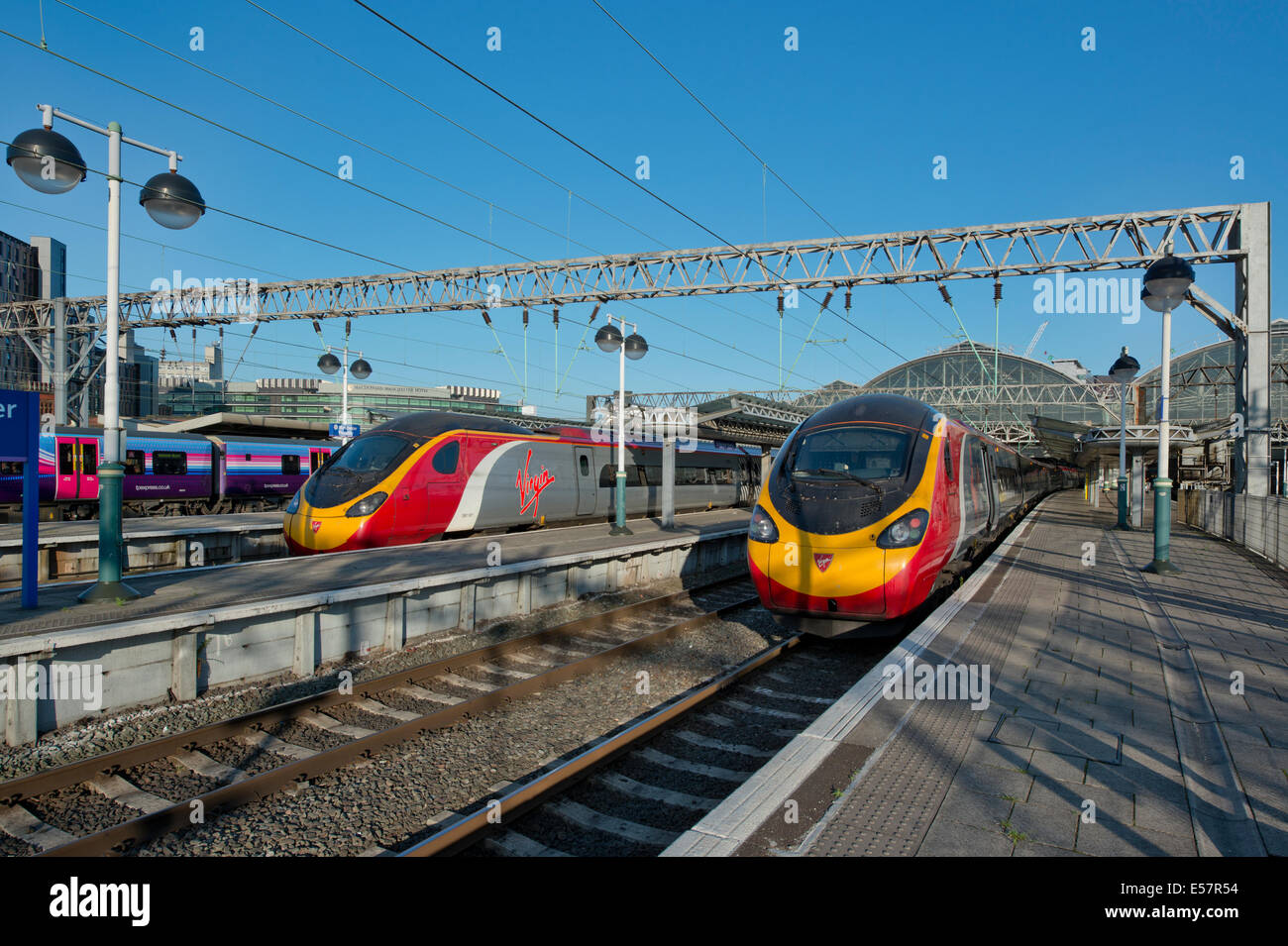 Two Virgin Class 390 Pendolino trains in the platforms of Manchester Piccadilly Rail Station. Stock Photo