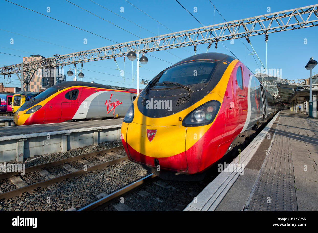 Two Virgin Class 390 Pendolino trains in the platforms of Manchester Piccadilly Rail Station. Stock Photo