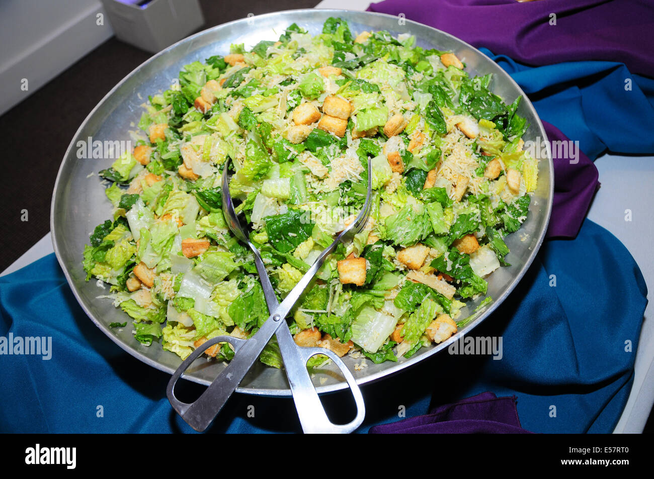 A large bowl of caesar salad at a wedding buffet. Stock Photo