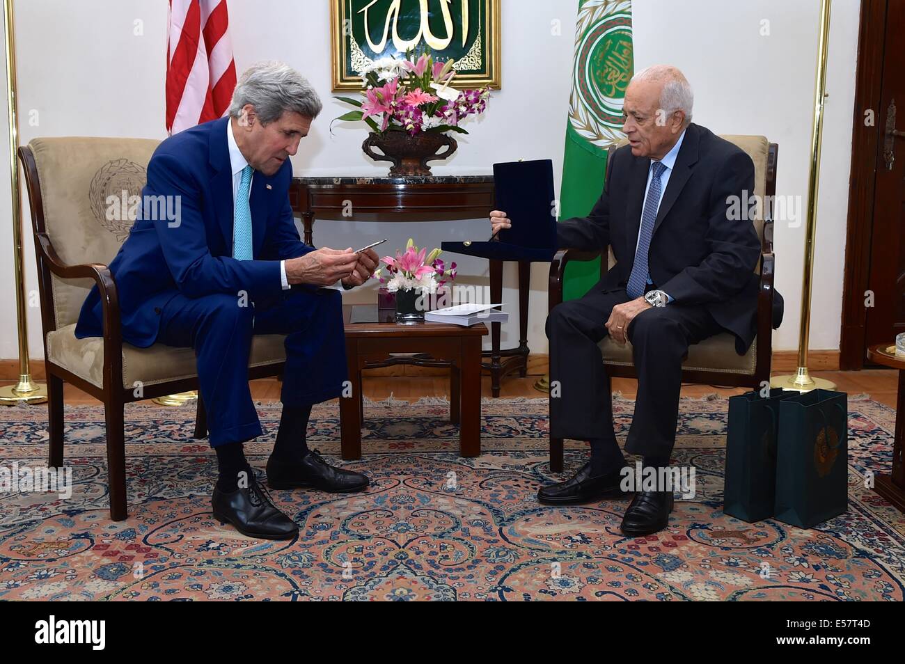 Cairo, Egypt. 22st July, 2014. US Secretary of State John Kerry examines a medallion gifted to him by Arab League Secretary-General Nabil al-Araby during discussion on a possible ceasefire between Israeli and Hamas forces fighting in the Gaza Strip at Arab League Headquarters July 22, 2014 in Cairo, Egypt. Credit:  Planetpix/Alamy Live News Stock Photo