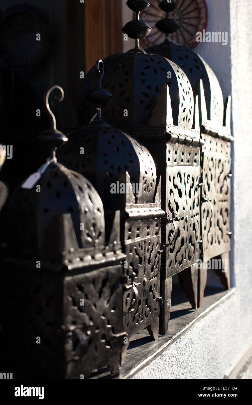 souvenir black metal iron bronze Arabic Moroccan Moorish lanterns lamps in sunlight in market place Stock Photo