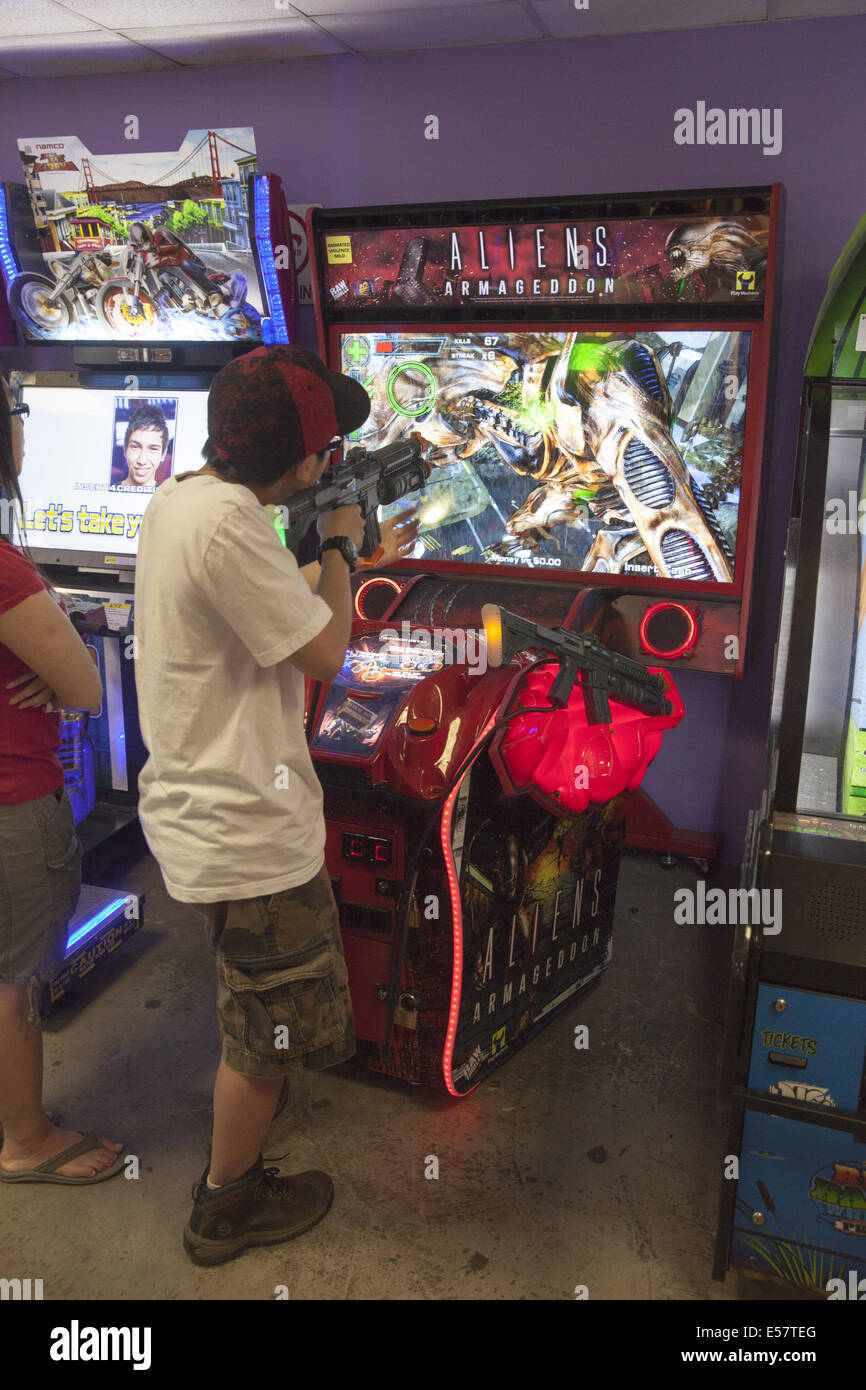 Coney Island; Video game arcades with violent games are popular with with adolescent and teenage boys along with some adults Stock Photo