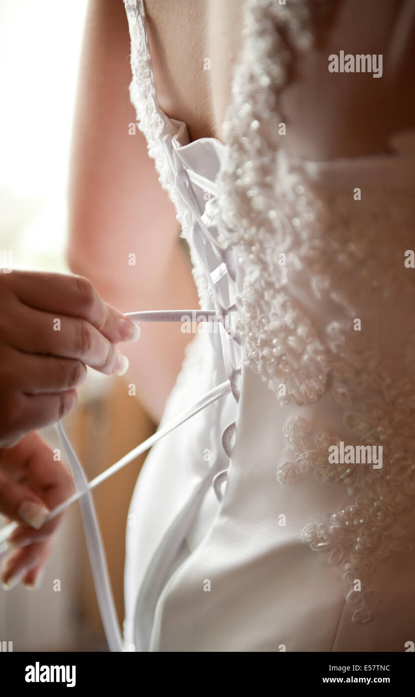 Bridal prepare white dress bind Stock Photo