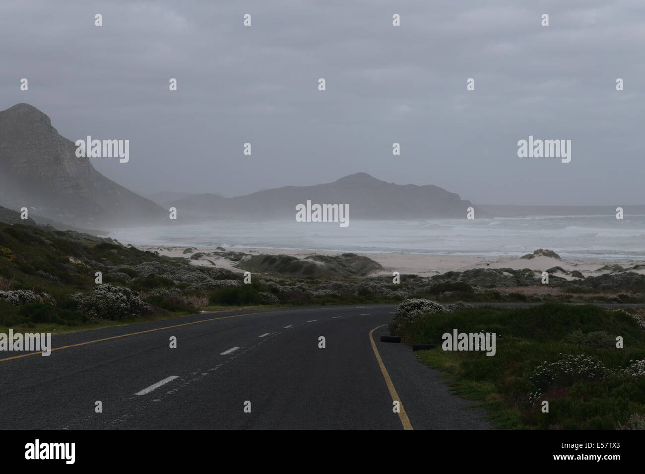 Road leading to Soetwater (Cape Peninsula, South Africa), with Misty Cliffs in the background, on a wintery day Stock Photo