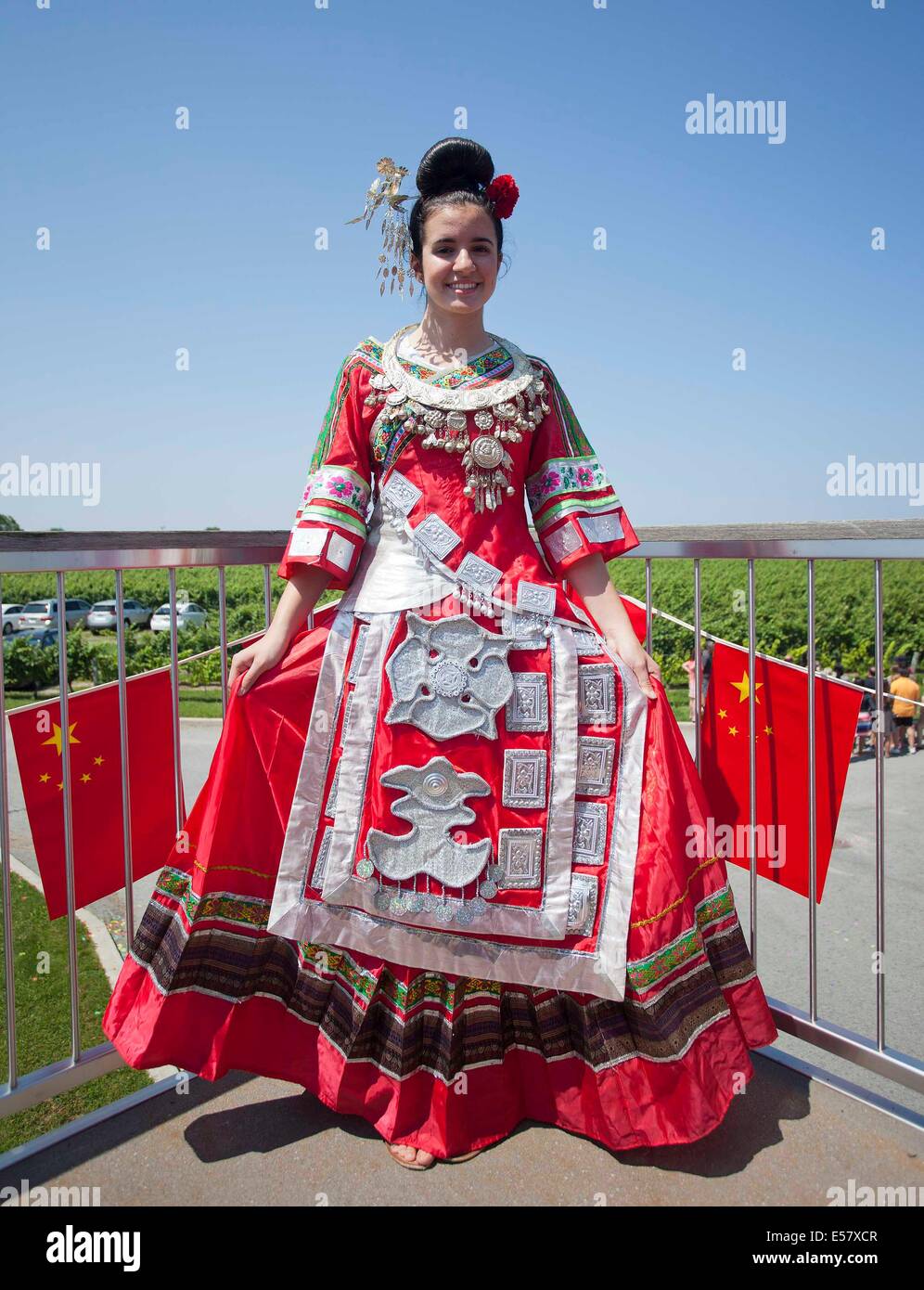 Toronto, Canada. 22nd July, 2014. A girl poses for photos wearing Miao  ethnic group traditional clothes during the "Colorful Guizhou Exhibition"  in the Town of Niagara-on-the-Lake, Ontario, Canada, July 22, 2014.  Featuring