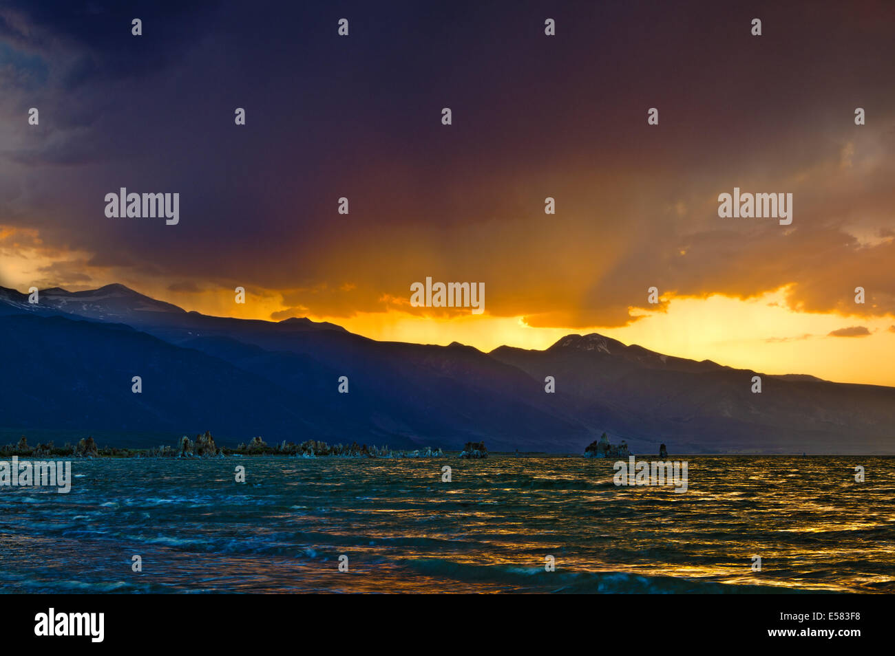 hdr image of dark and dramatic sunset with orange sun rays over Mono Lake Stock Photo