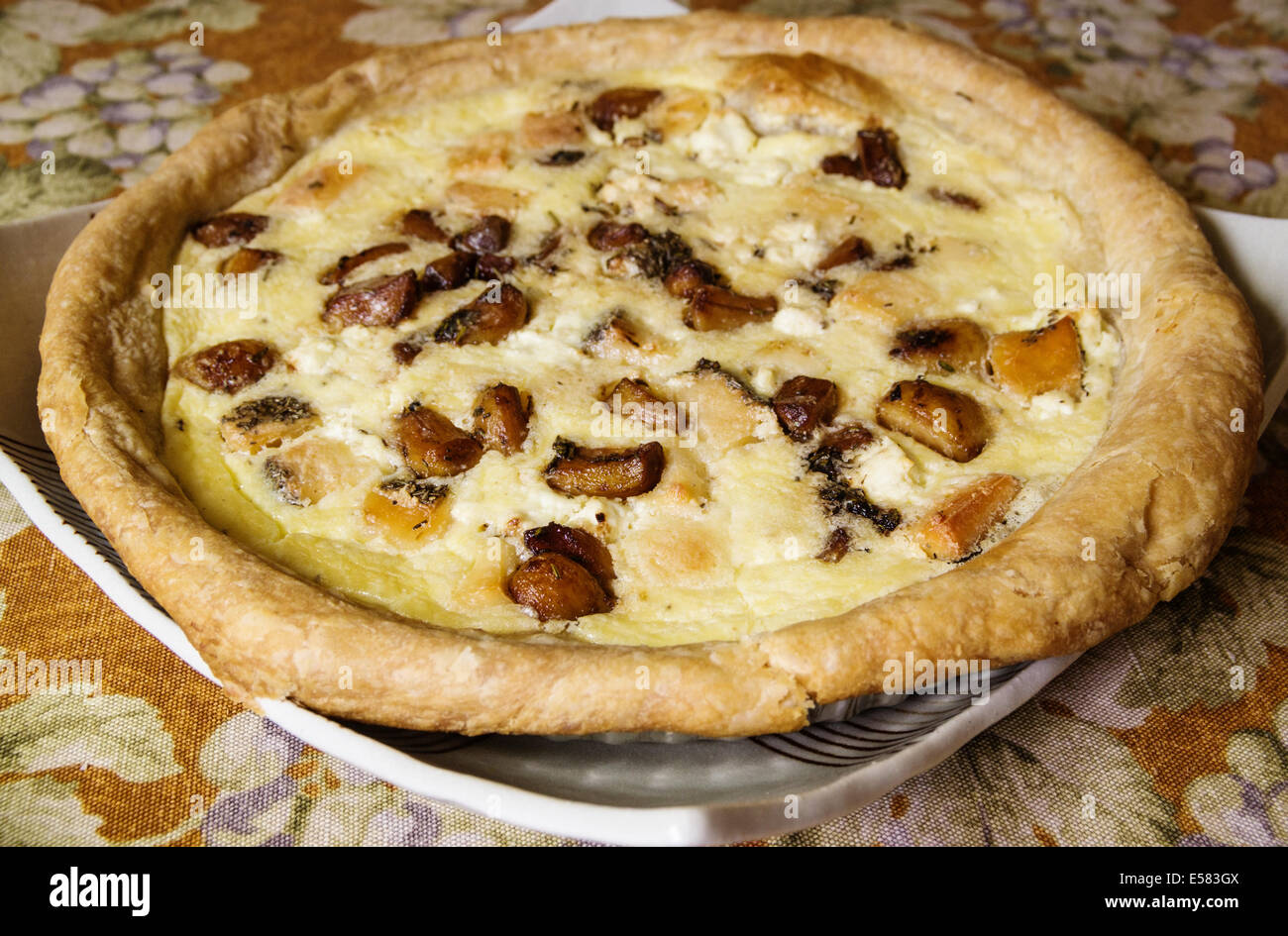 home made roasted garlic torte on serving platter Stock Photo
