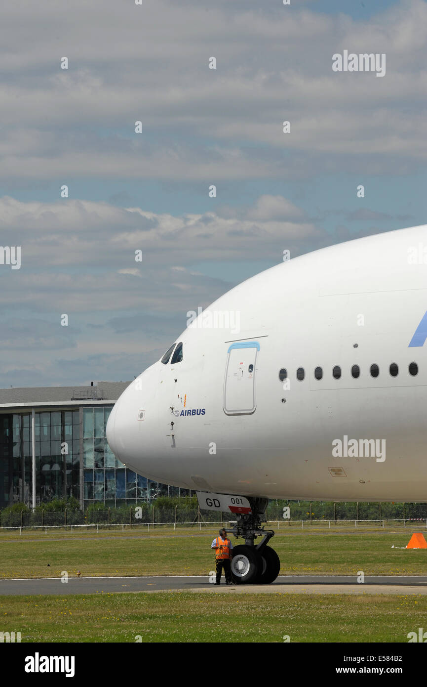 Airbus A380 on runway with man standing by nosewheel Stock Photo