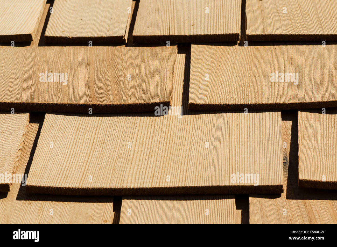new wooden cedar roof shingles detail on a roof Stock Photo
