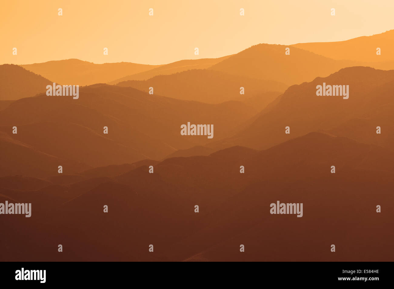 multiple hills and horizon lines in golden evening light Stock Photo
