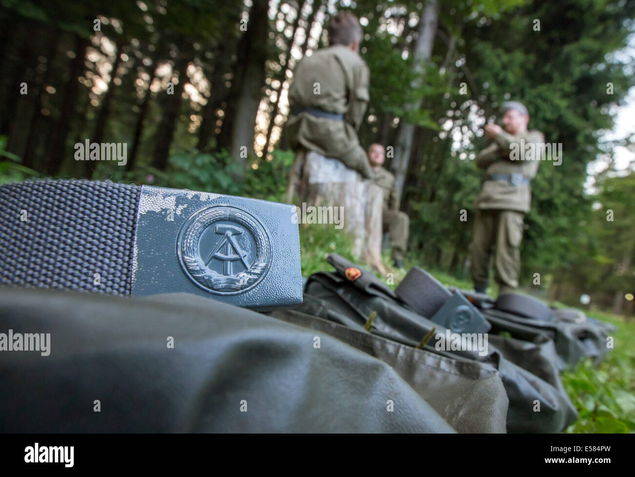 Visitors wear uniforms of the former National People's Army (NPA) of the German Democratic Republic (GDR) during the reenactment of a military exercise at the Bunker Museum Frauenwald in Frauenwald, Germany, 19 July 2014. The private museum offers a trip back in time including an overnight stay in the former bunker complex of the GDR's Ministry for State Security (Stasi). The bunker complex is 3,600 square metres in size and was supposed to allow the district command Suhl to continue operating in case of war. Photo: Michael Reichel /ZB Stock Photo