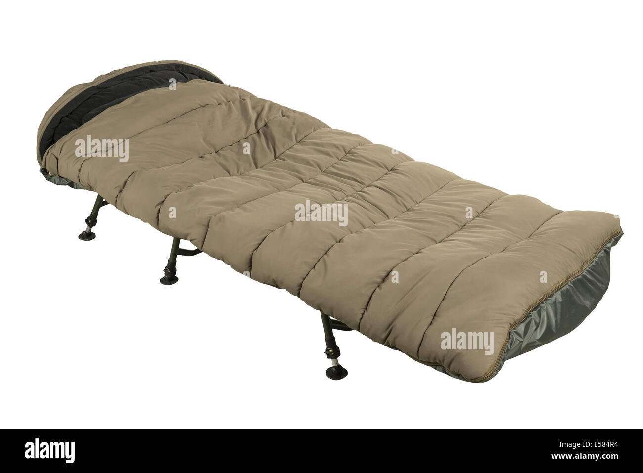 Green camp bed with sleeping bag isolated on white background Stock