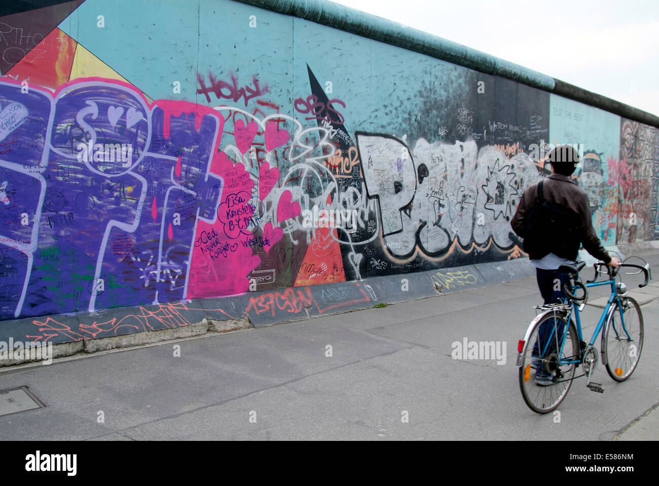Cyclist at East Side Gallery 'Berlin wall' Europe Germany Berlin Friedrichshain Stock Photo