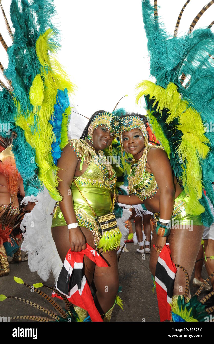 Two women at Notting Hill Carnival London wearing traditional Caribbean Festival clothing Stock Photo